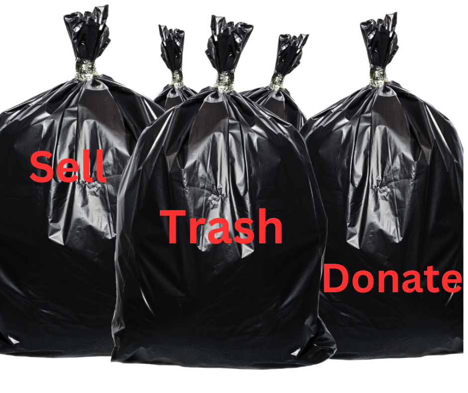 3 black trash bags labeled in red trash, sell and donate.